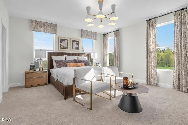 a spacious bedroom with a bed and chandelier