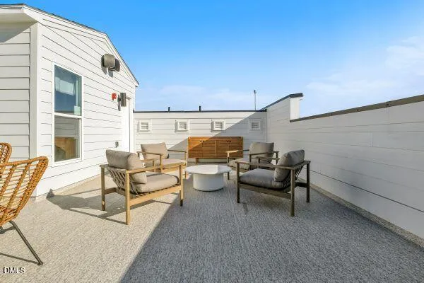 a view of a patio with table and chairs and couches