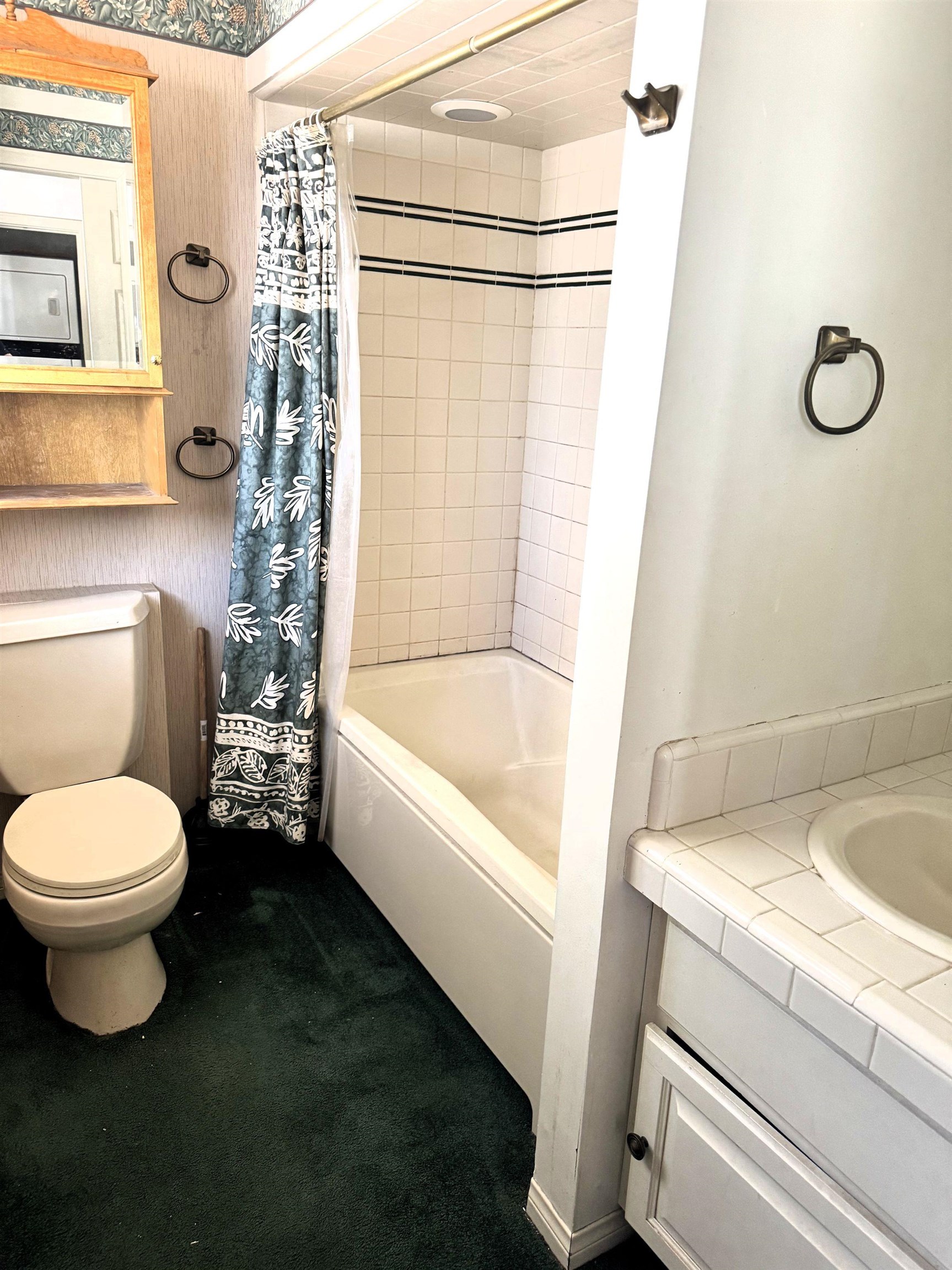 4 Kelley Road, Unit 1 Mammoth Lakes, CA 93546 - Photo 12 of 19 Bathroom featuring a built-in bathtub with white tile surround, single vanity with tiled countertop