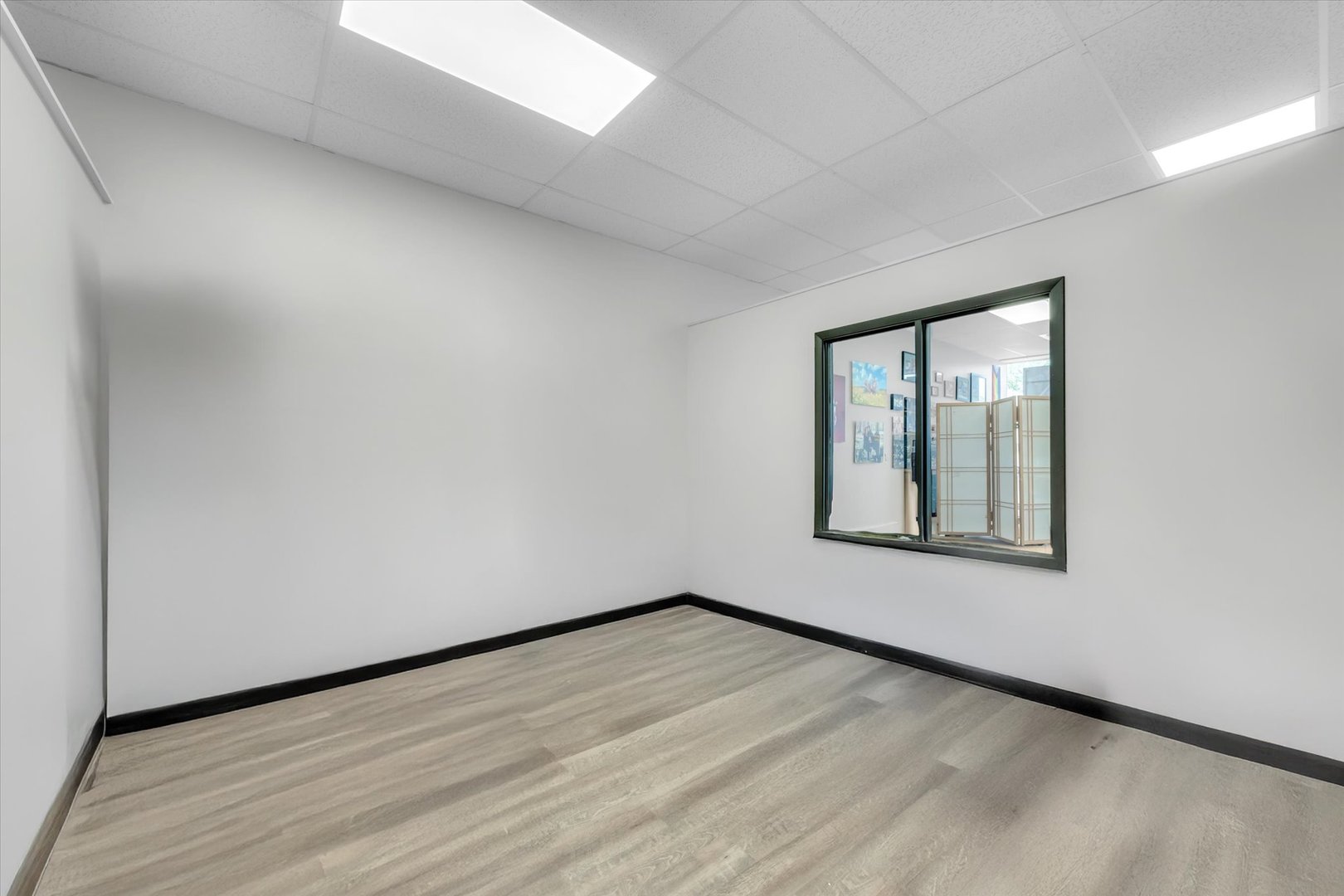 18660 Dixie Highway Homewood, IL 60430 - Photo 7 of 53 a view of an empty room with wooden floor and a window