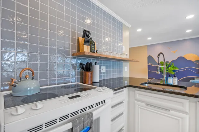 a kitchen with a sink and a stove top oven