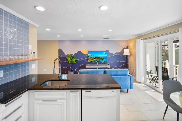 a kitchen with stainless steel appliances granite countertop a sink and a white cabinets