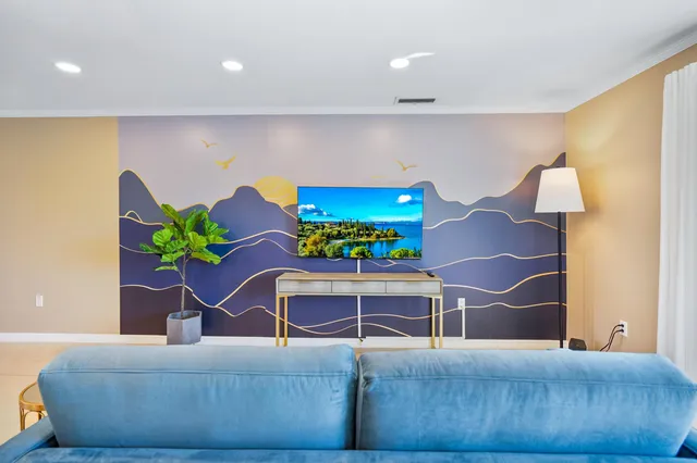 a living room with furniture flowerpot and a lamp