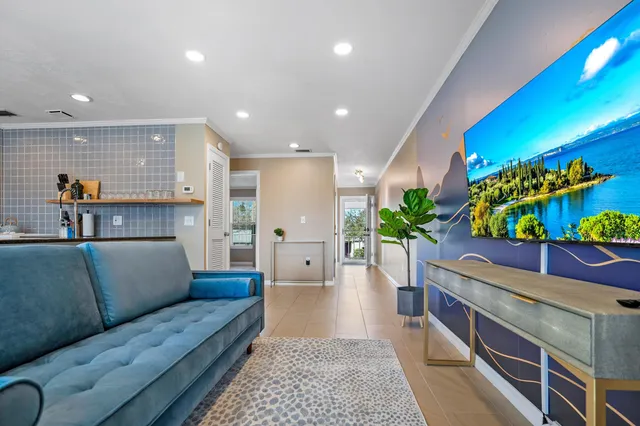 a living room with furniture flowerpot and a potted plant