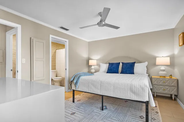 a bedroom with a bed and a lamp