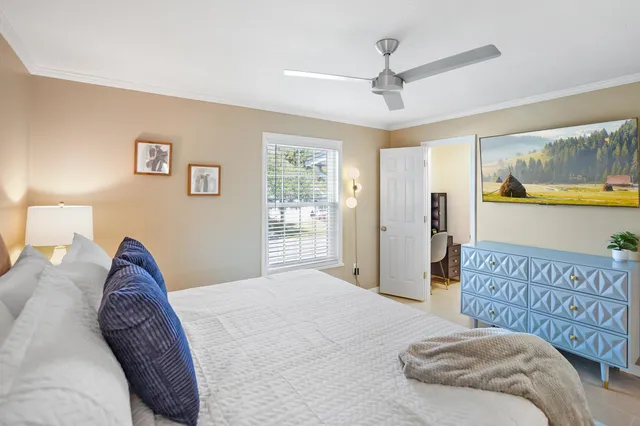 a bedroom with a large bed and a chandelier
