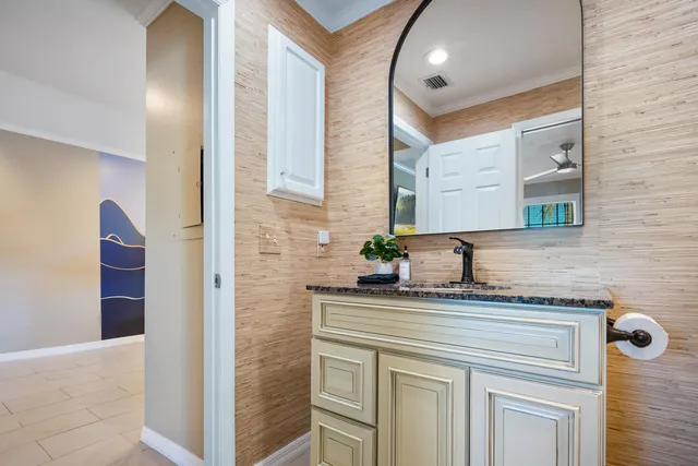 a bathroom with a granite countertop sink and a mirror