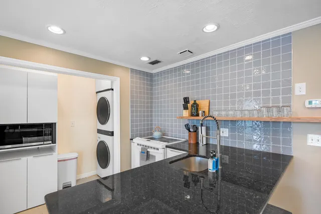 a kitchen with a sink and a stove top oven