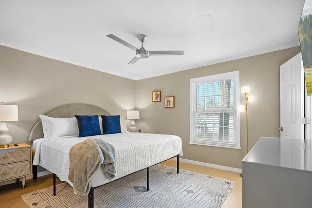 a bedroom with a large bed and a window