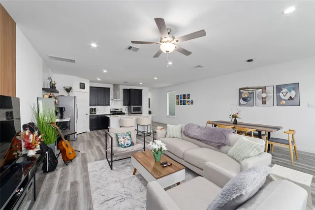 a living room with furniture and kitchen view