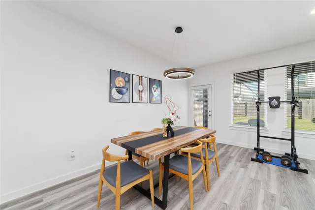 a view of a room with furniture and wooden floor