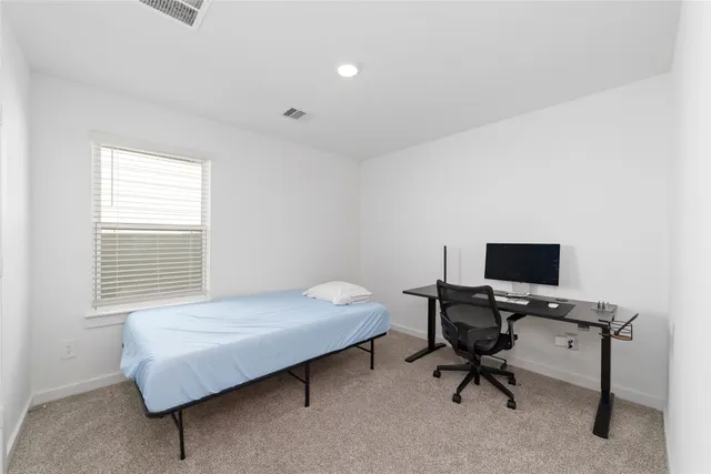 a bedroom with a workspace