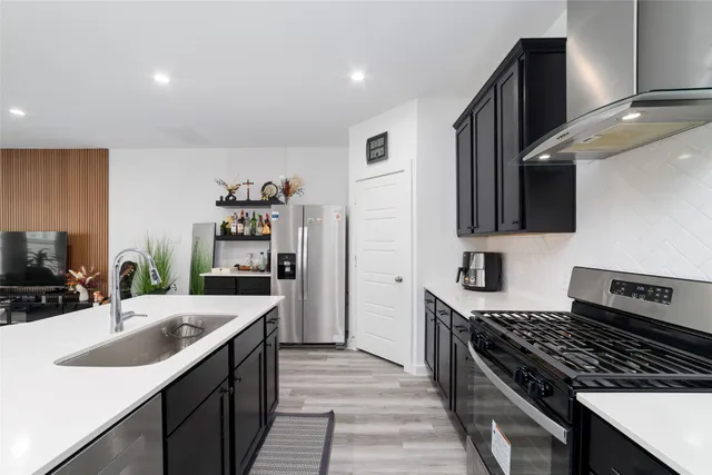 a kitchen with a sink stove and cabinets