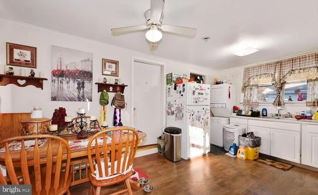 a room with furniture a ceiling fan and a window