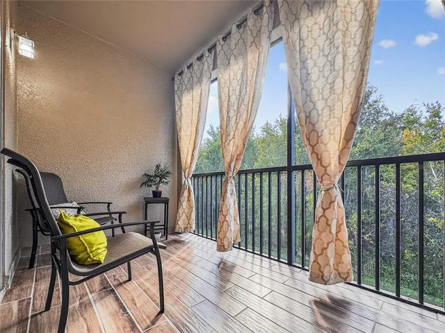a view of a balcony with chairs