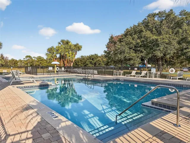 a view of swimming pool with outdoor seating and yard