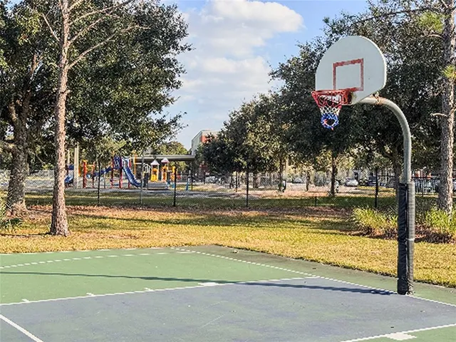 a view of a tennis court with a small yard