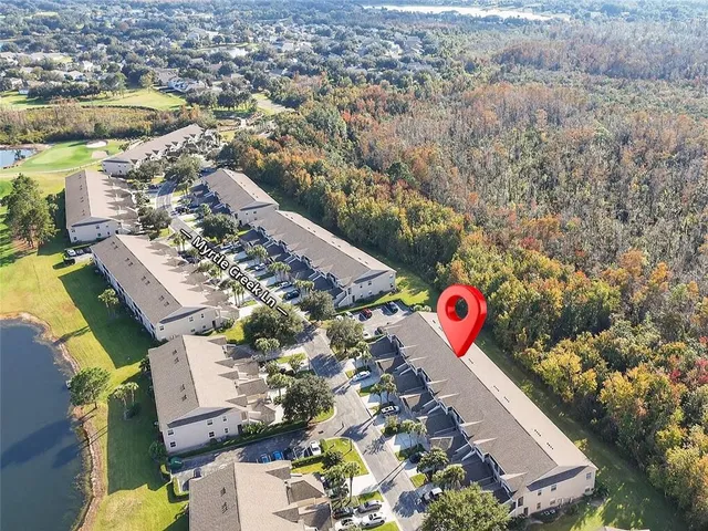 an aerial view of residential houses with outdoor space and swimming pool
