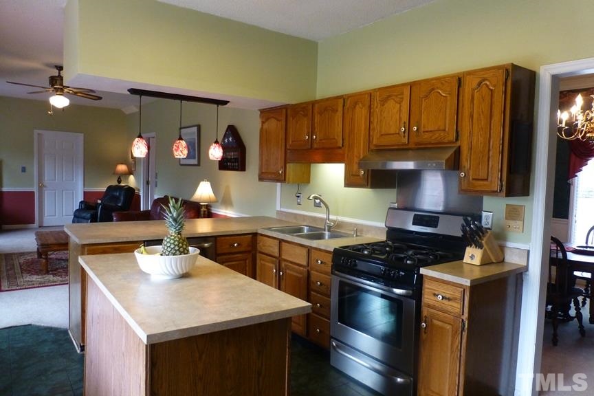 233 Henry Road Burlington, NC 27215 - Photo 8 of 25 Kitchen island and stainless steel appliances