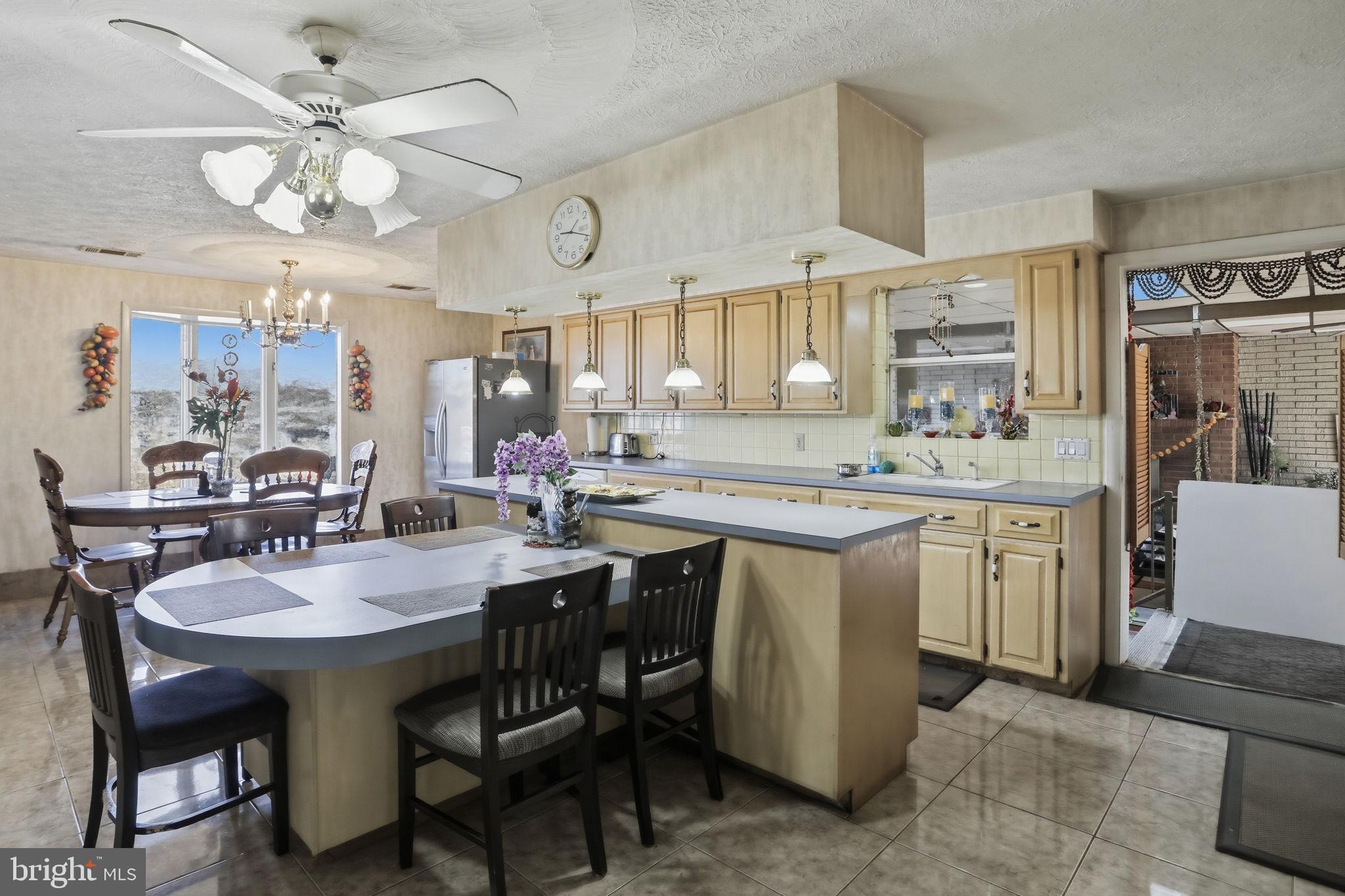 501 South Breezewood Road Breezewood, PA 15533 - Photo 18 of 43 a kitchen with a sink a stove a dining table and chairs