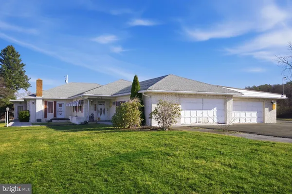 a front view of a house with a yard and balcony
