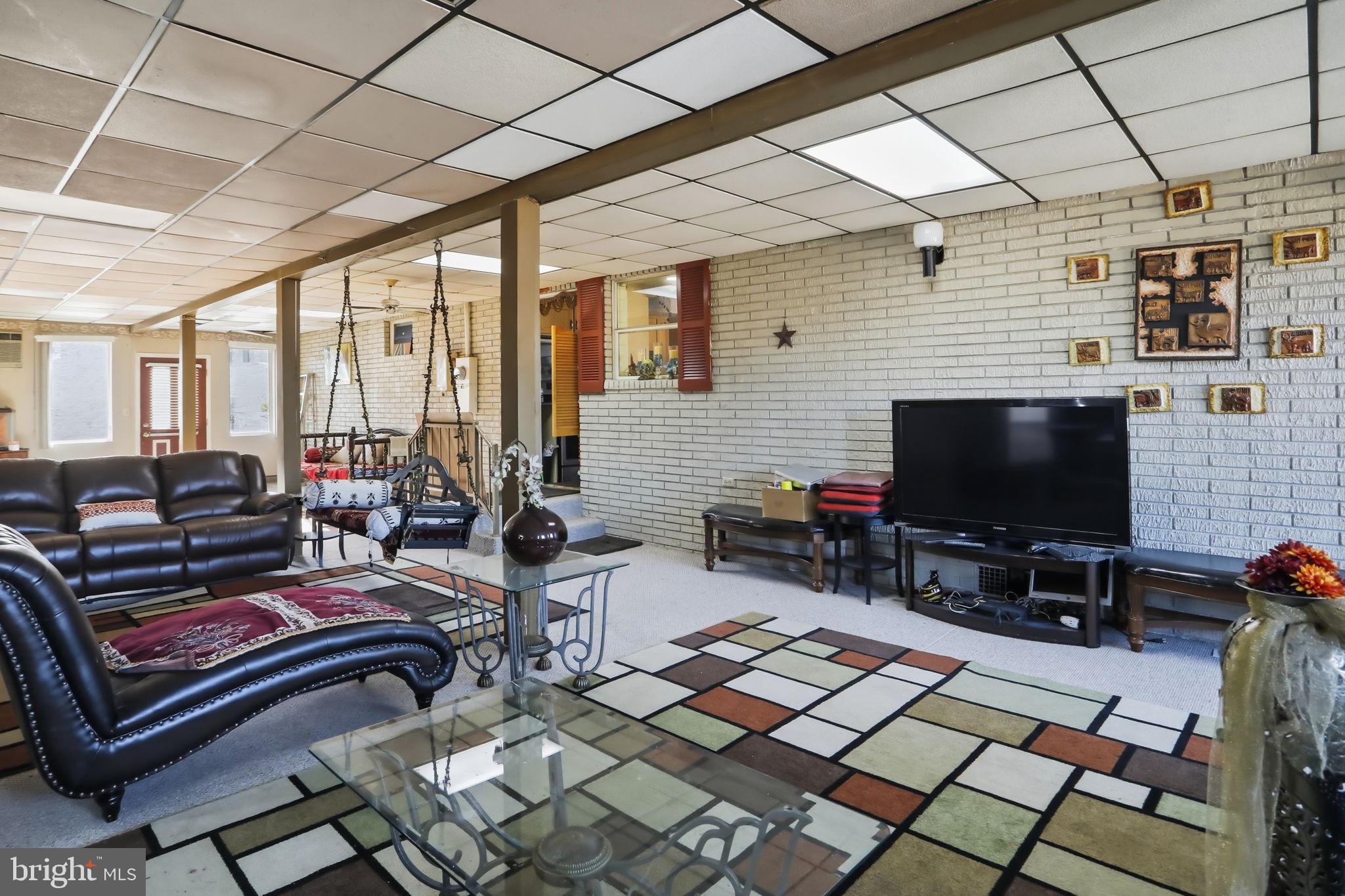 501 South Breezewood Road Breezewood, PA 15533 - Photo 22 of 43 a outdoor living space with patio furniture and a flat screen tv
