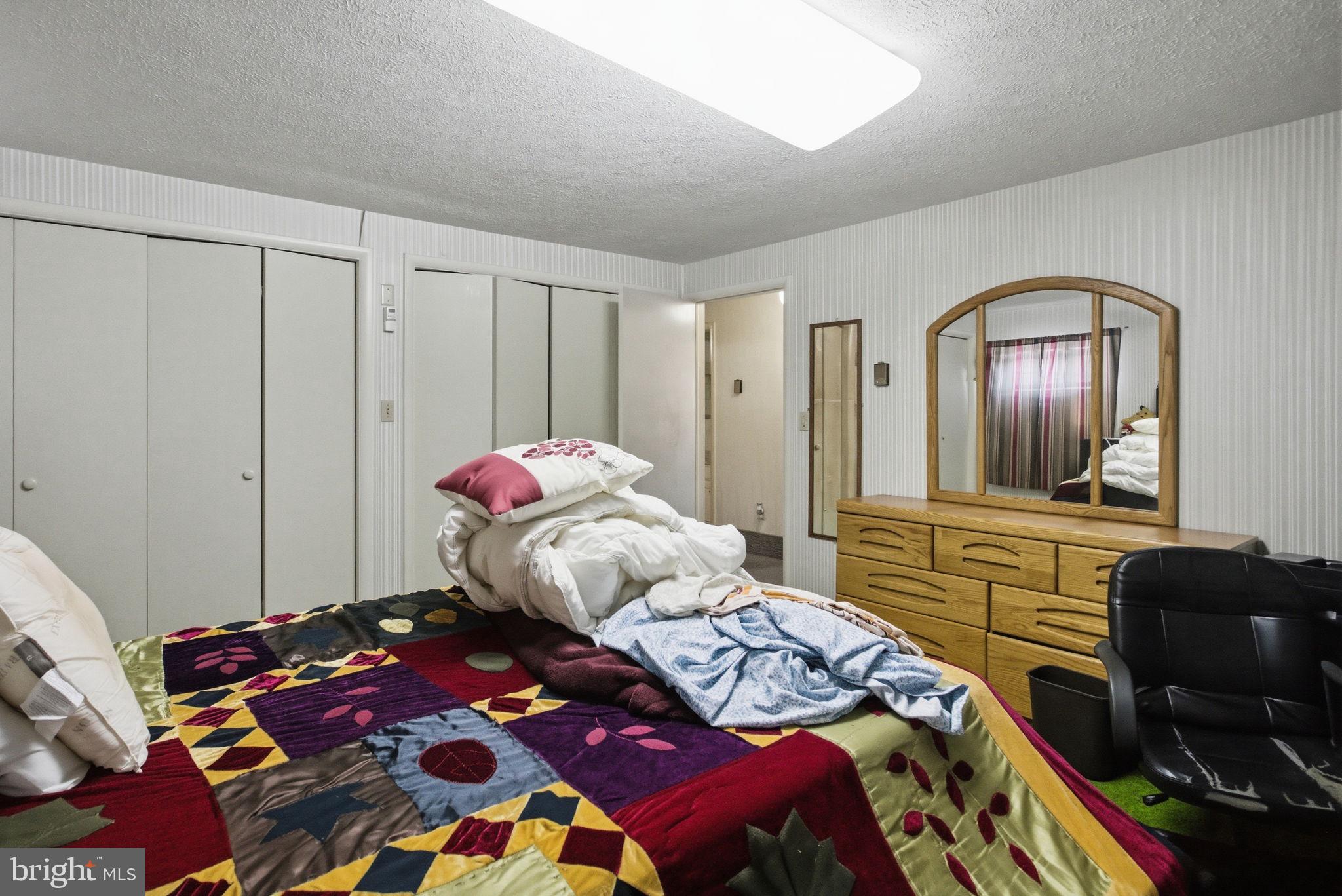 501 South Breezewood Road Breezewood, PA 15533 - Photo 24 of 43 a bedroom with a bed and a chandelier