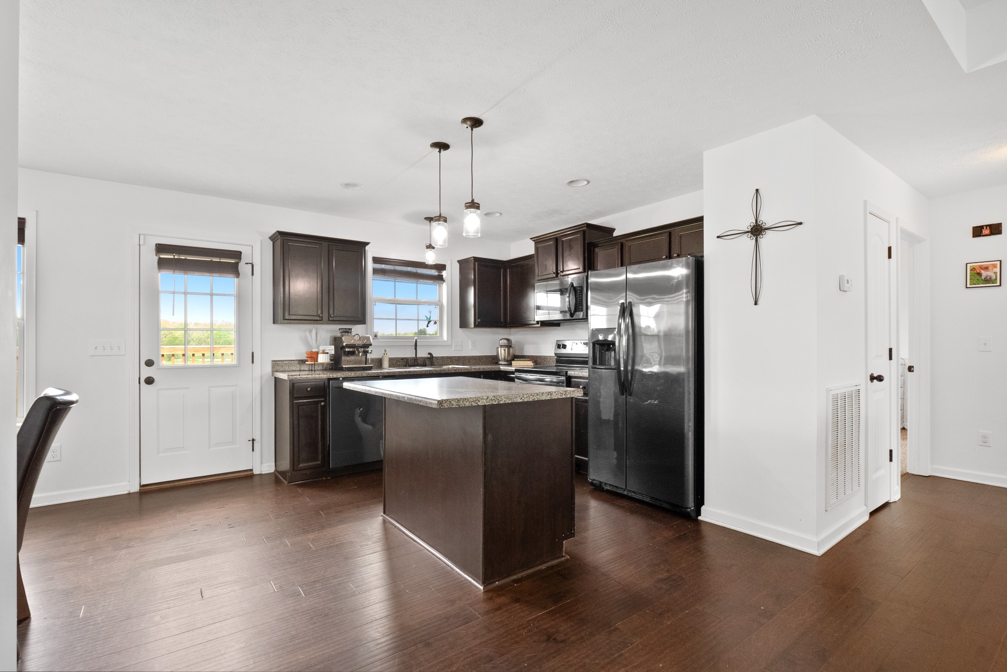 1010 Gil Hodges Road Portland, TN 37148 - Photo 6 of 22 a kitchen with stainless steel appliances granite countertop a refrigerator a sink dishwasher a stove top oven a refrigerator with island and chairs