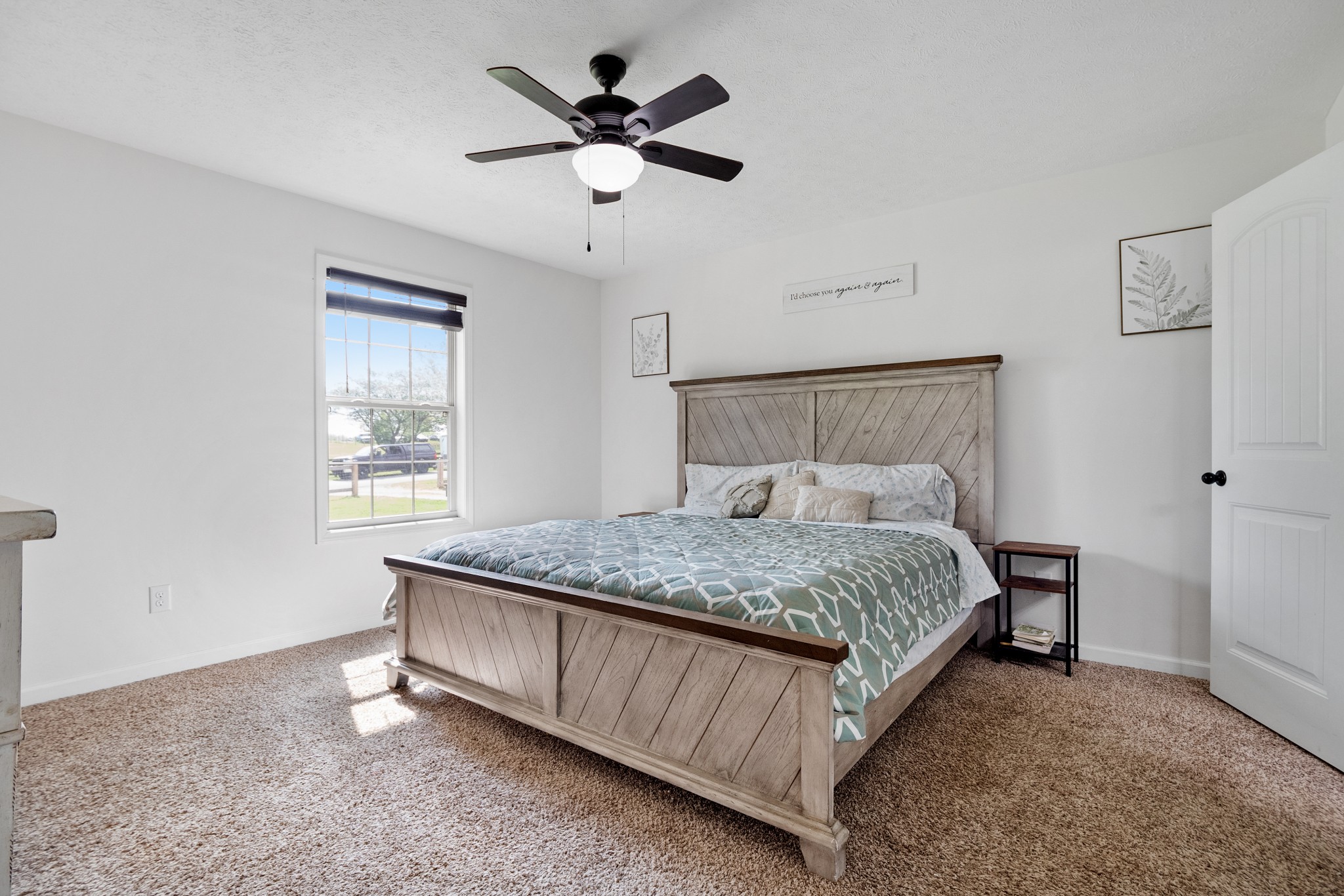 1010 Gil Hodges Road Portland, TN 37148 - Photo 10 of 22 a bedroom with a bed chandelier and a window