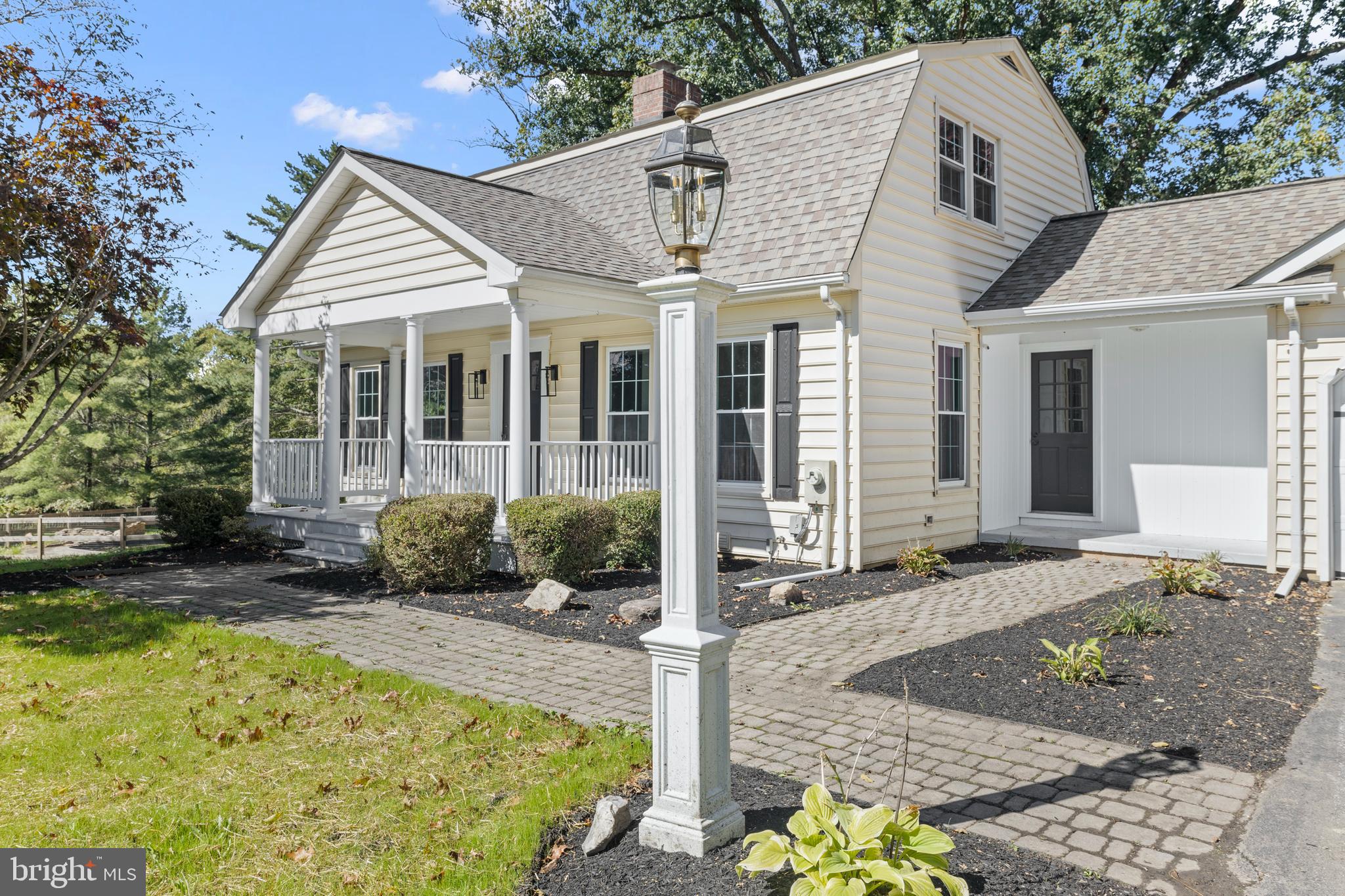 6912 Stratford Drive Sykesville, MD 21784 - Photo 2 of 46 a view of a white house with large windows and plants