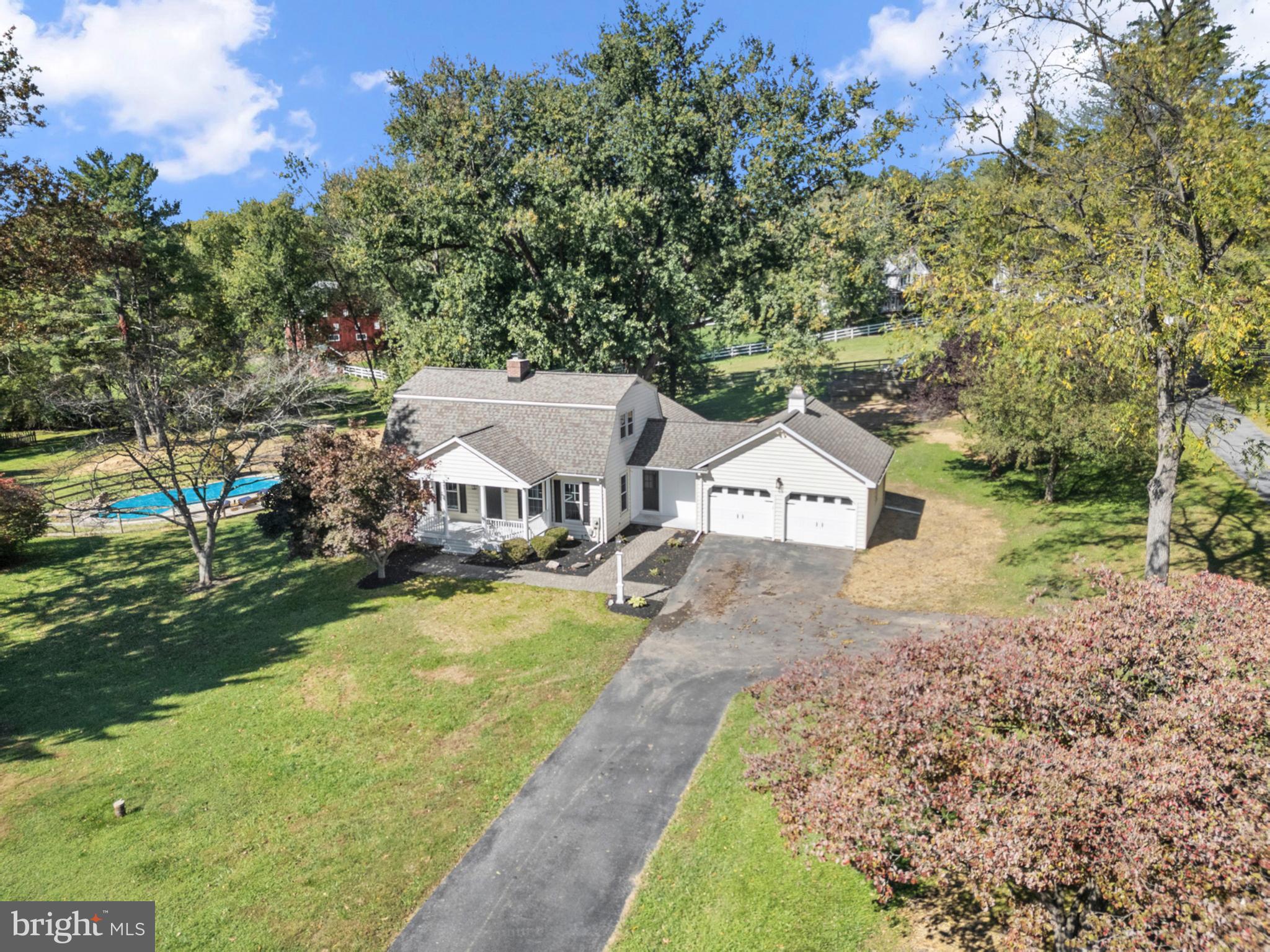 6912 Stratford Drive Sykesville, MD 21784 - Photo 40 of 46 a view of a big house with a big yard plants and large trees