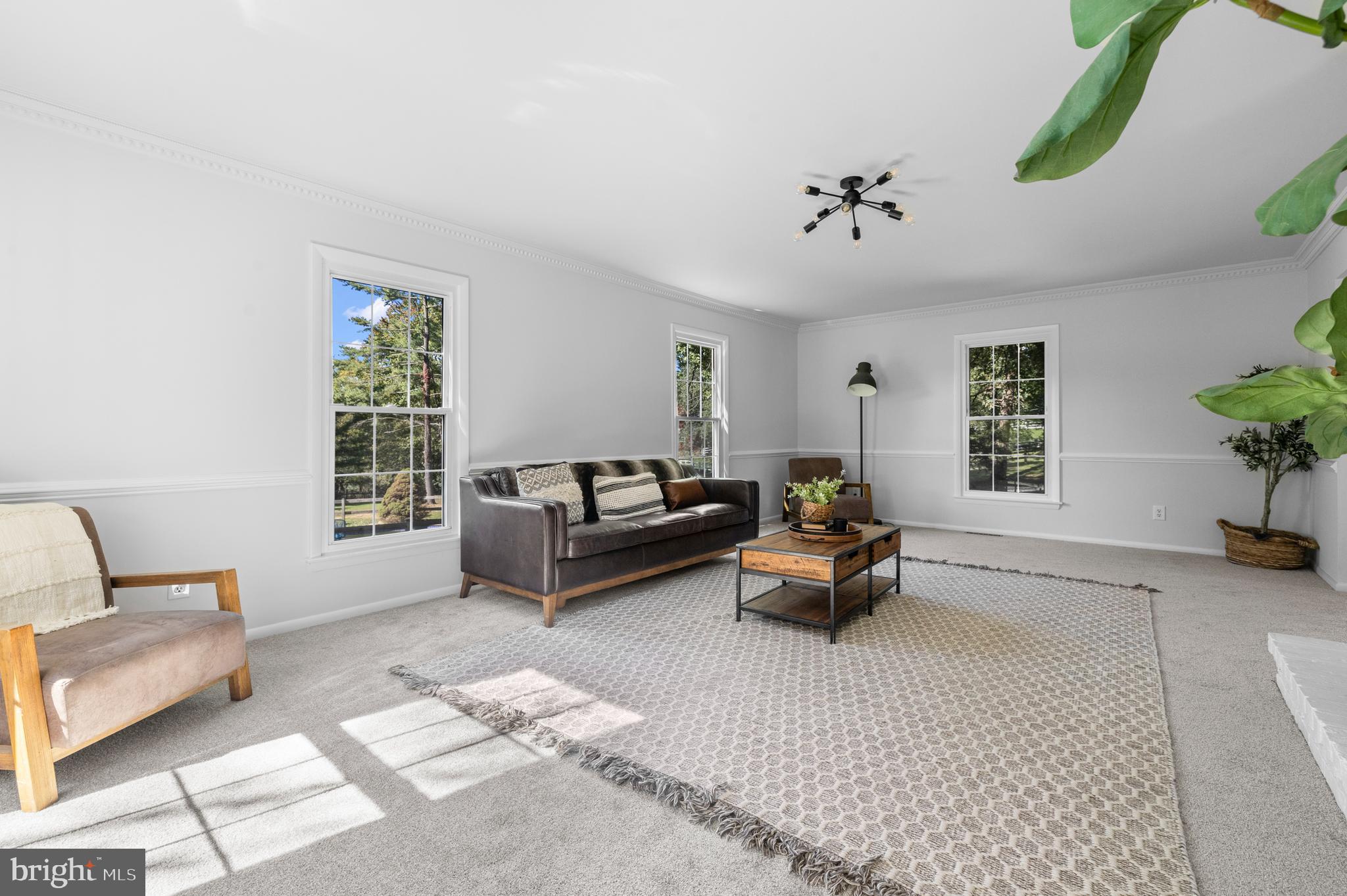 6912 Stratford Drive Sykesville, MD 21784 - Photo 4 of 46 a living room with furniture and a chandelier