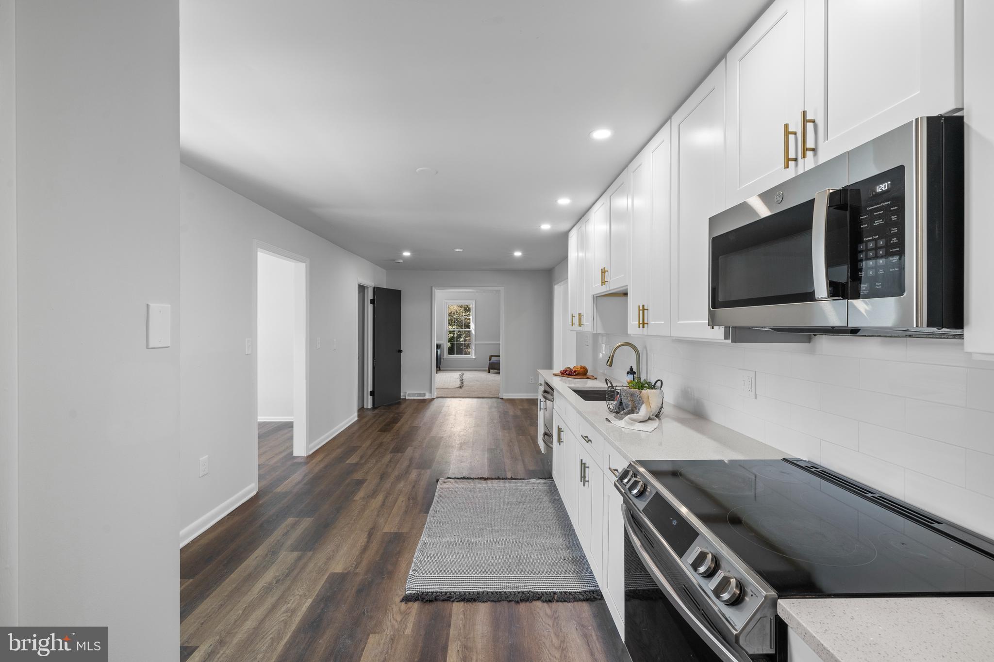 6912 Stratford Drive Sykesville, MD 21784 - Photo 10 of 46 a view of living room kitchen with furniture and flat screen tv