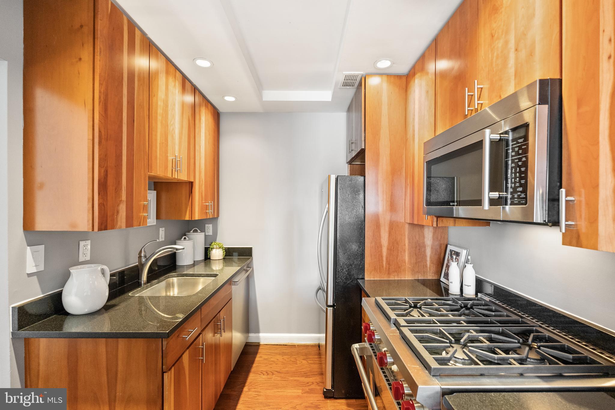 3251 Prospect Street Northwest, Unit 313 Washington, DC 20007 - Photo 13 of 43 a kitchen with stainless steel appliances granite countertop a stove and a sink