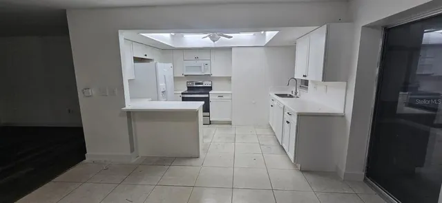 a kitchen with a sink a stove and refrigerator