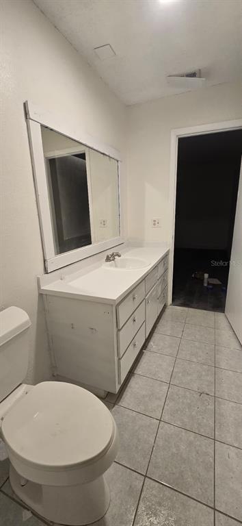 526 Reading Street Northwest Port Charlotte, FL 33952 - Photo 3 of 12 a bathroom with a toilet sink and mirror