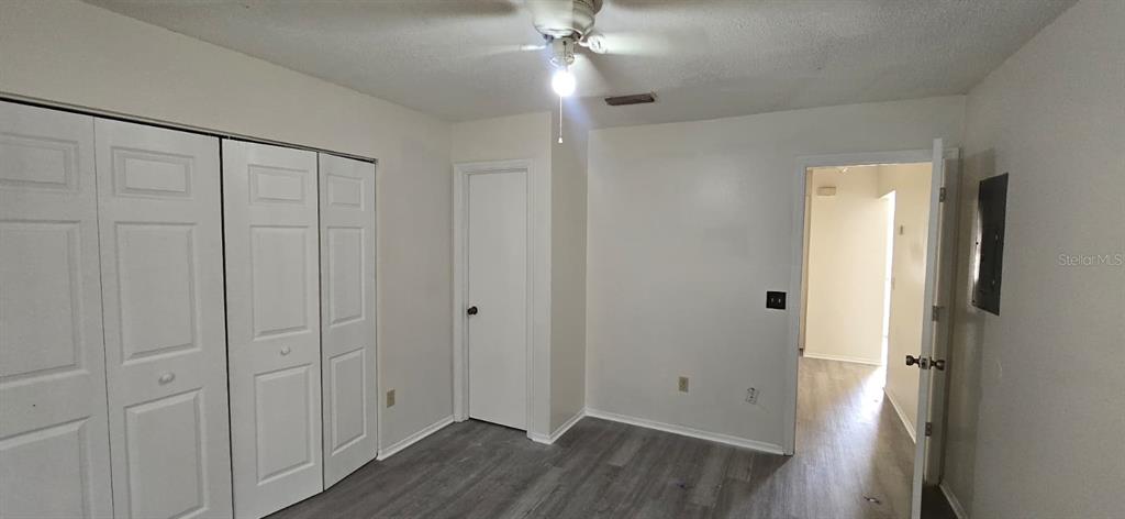 526 Reading Street Northwest Port Charlotte, FL 33952 - Photo 8 of 12 a view of an empty room with wooden floor