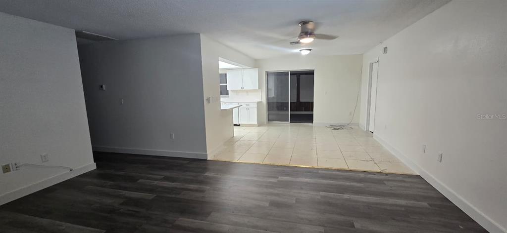 526 Reading Street Northwest Port Charlotte, FL 33952 - Photo 10 of 12 a view of an empty room with wooden floor