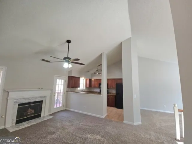 a view of a kitchen with a sink and a fireplace