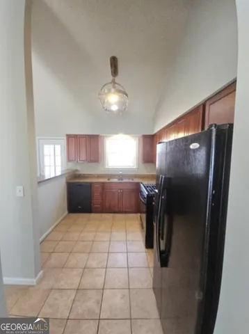 a kitchen with granite countertop a refrigerator and a sink