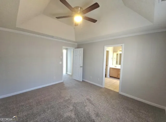 a view of an empty room and a ceiling fan