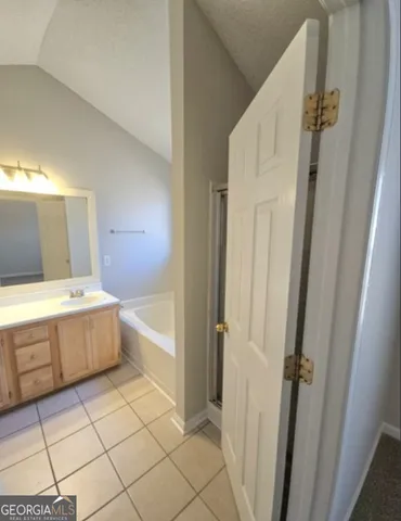 a bathroom with a bathtub and a sink