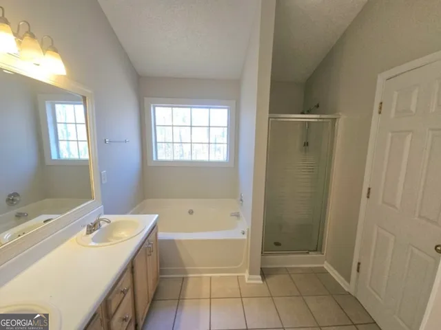 a bathroom with a bathtub sink and mirror