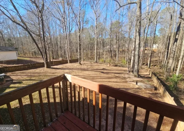 a view of a backyard with wooden fence