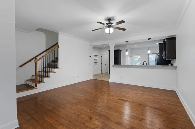 a view of a kitchen with wooden floor and a kitchen
