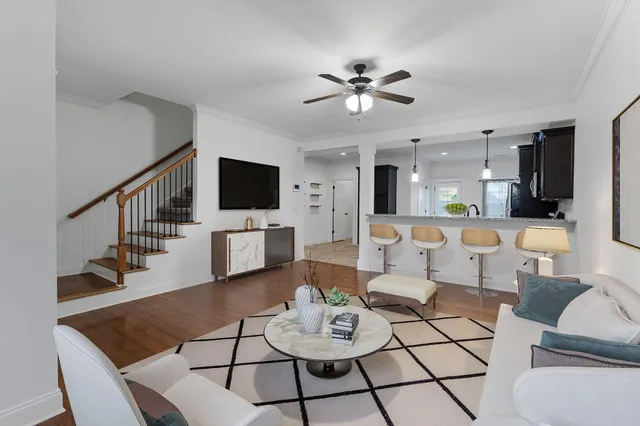 a living room with furniture and kitchen view