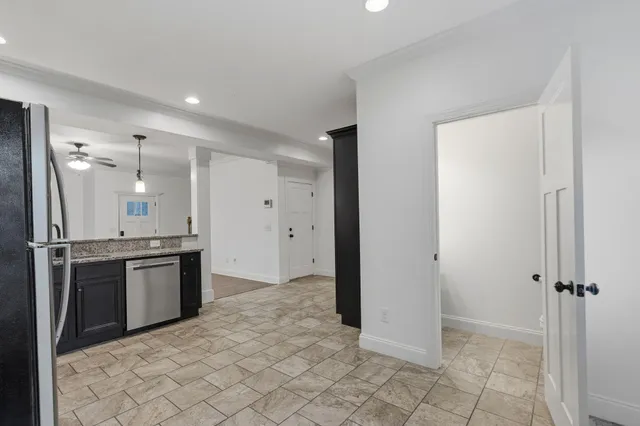 a kitchen with stainless steel appliances granite countertop a refrigerator and a sink