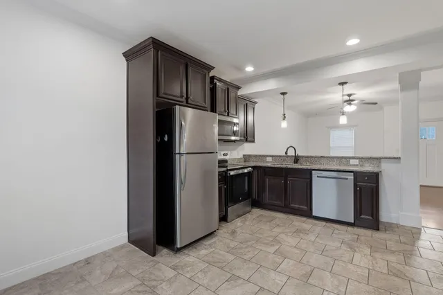 a kitchen with a refrigerator sink and stainless steel appliances