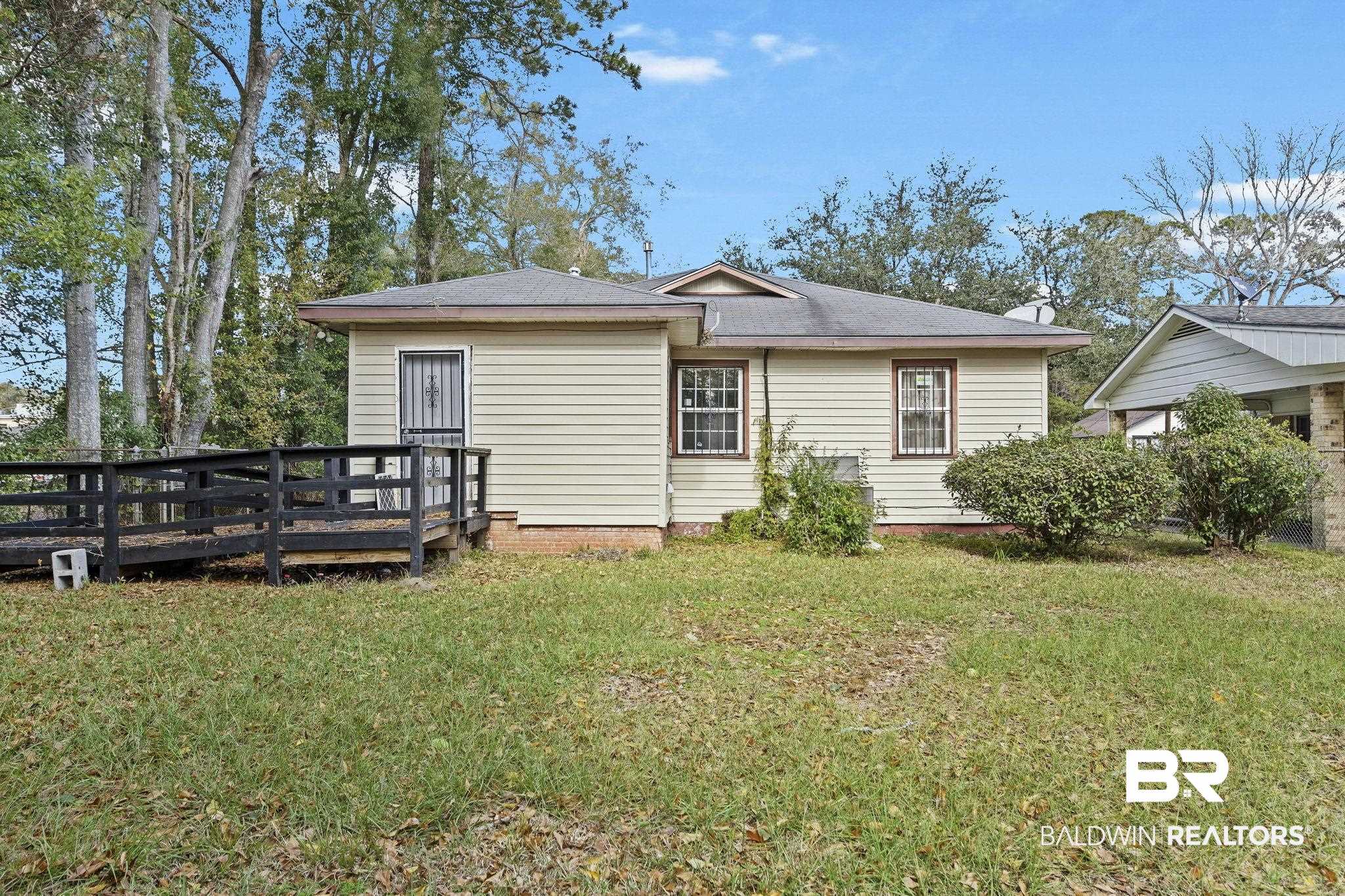 1665 Johnston Street Mobile, AL 36605 - Photo 14 of 17 Back of property with a deck and a lawn