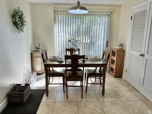 624 East Cutler Springville, UT 84663 - Photo 10 of 24 Dining area featuring light-toned tile flooring, a glass sliding door with vertical blinds, and a built-in louvered bi-fold door storage unit
